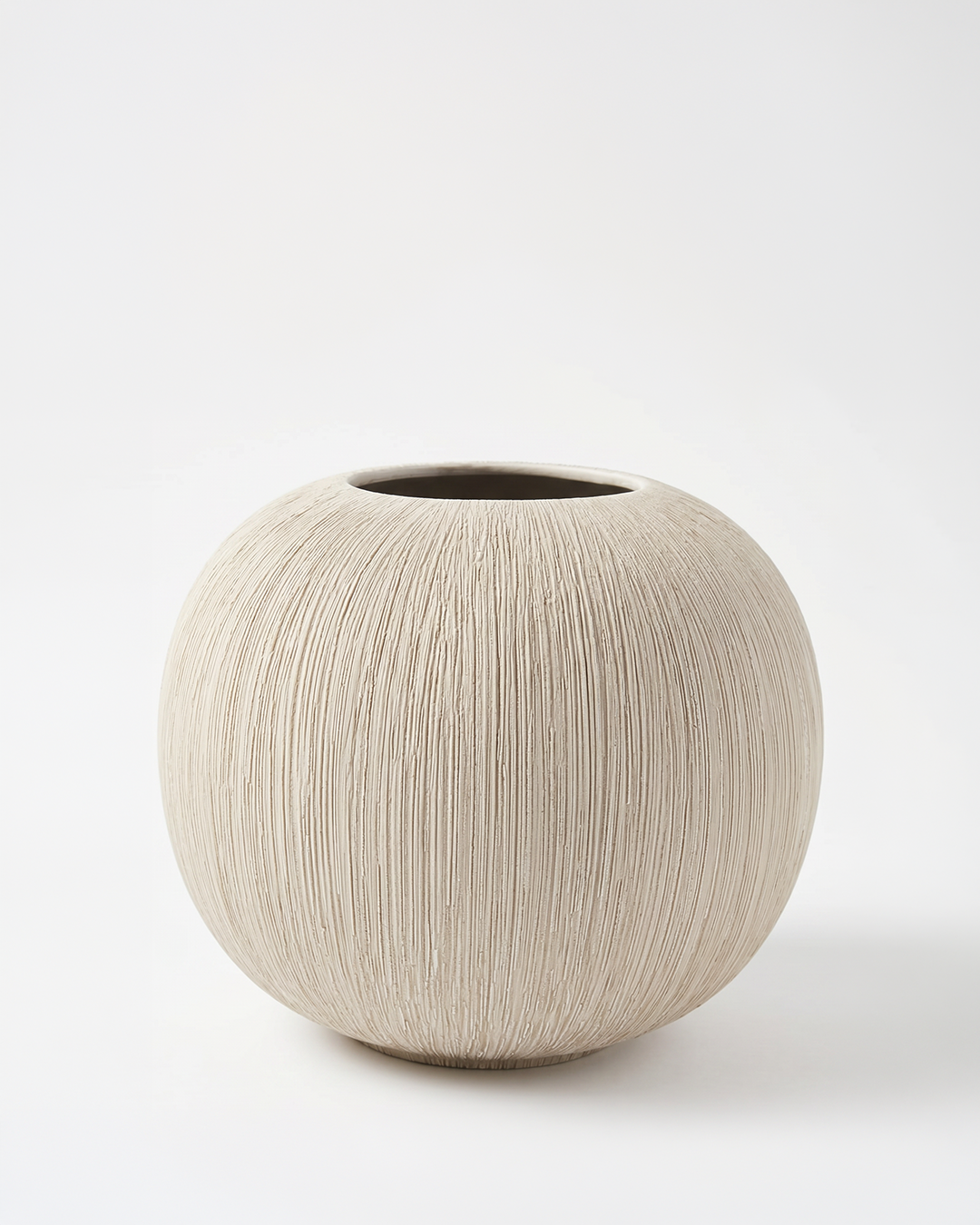 Round beige ceramic vase on a white background