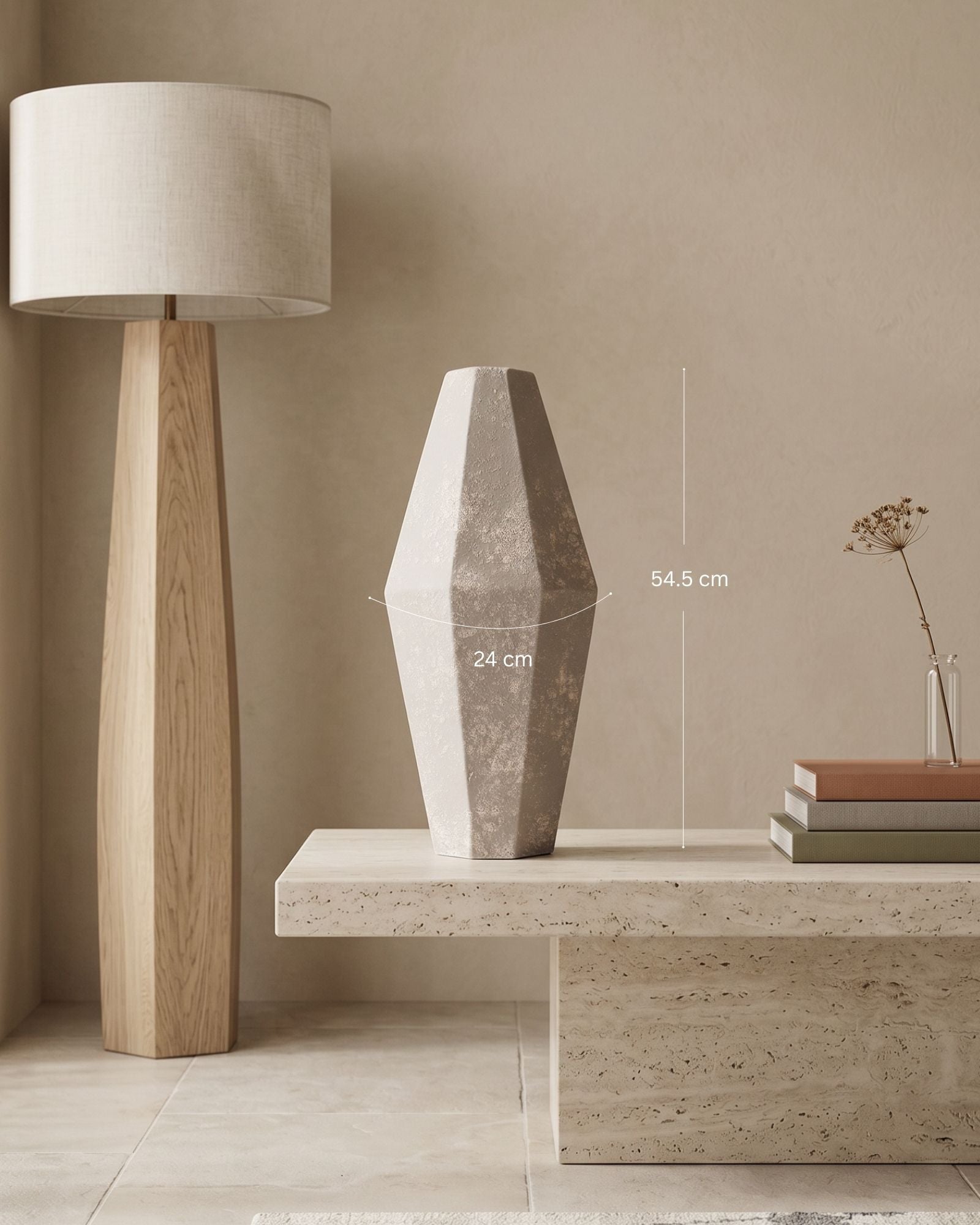 Decorative vase on a table with a lamp and books in a minimalistic setting