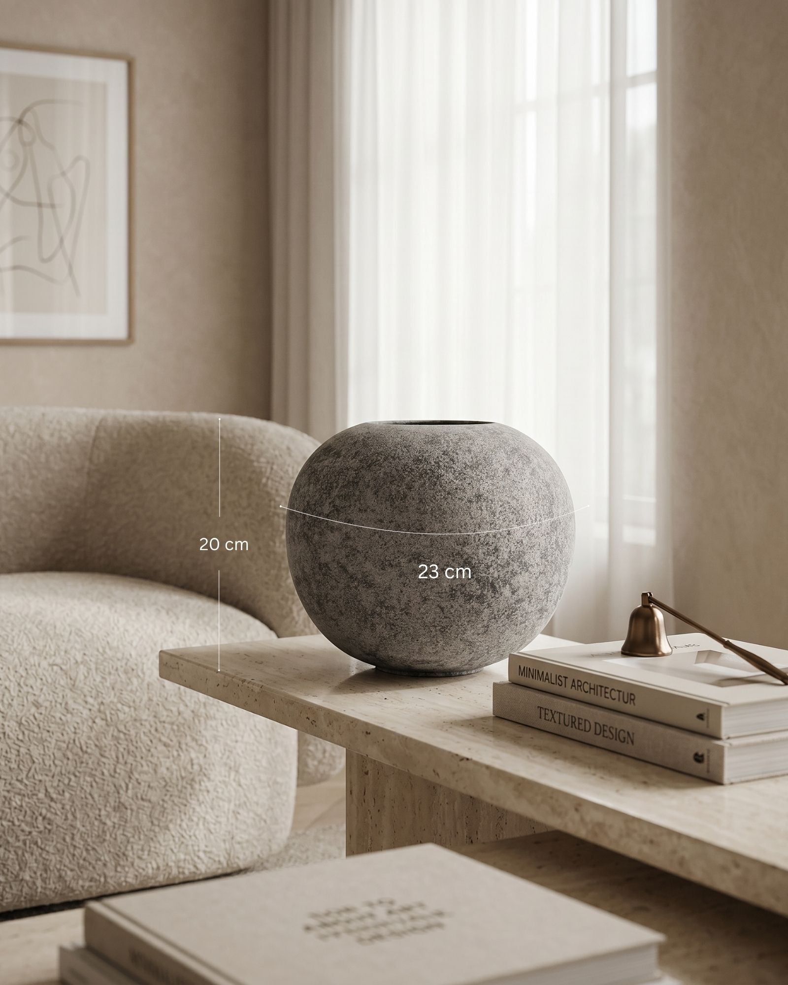 Decorative sphere on a wooden coffee table with books and a chair in a room.