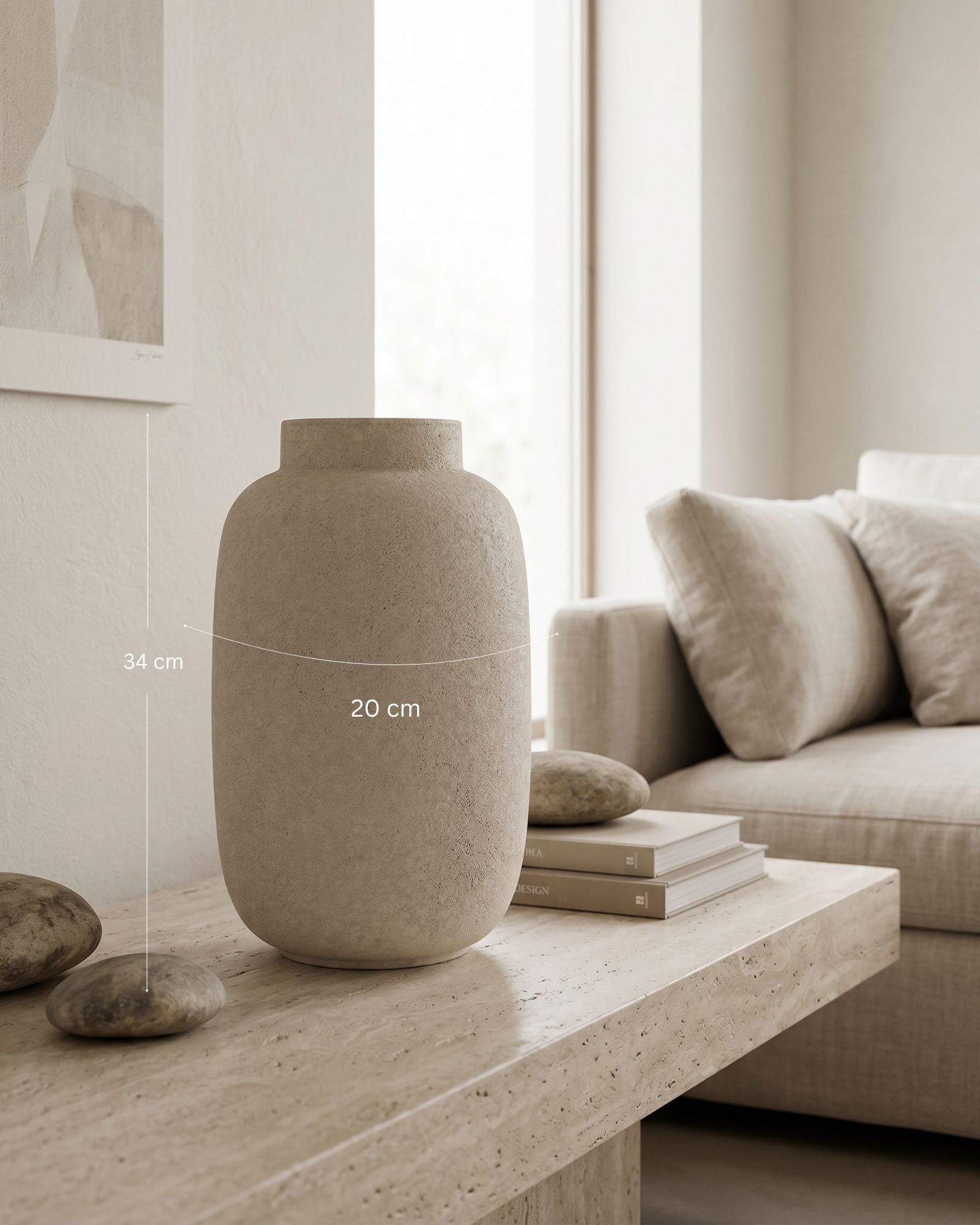 Beige ceramic vase on a wooden table with a sofa and books in the background