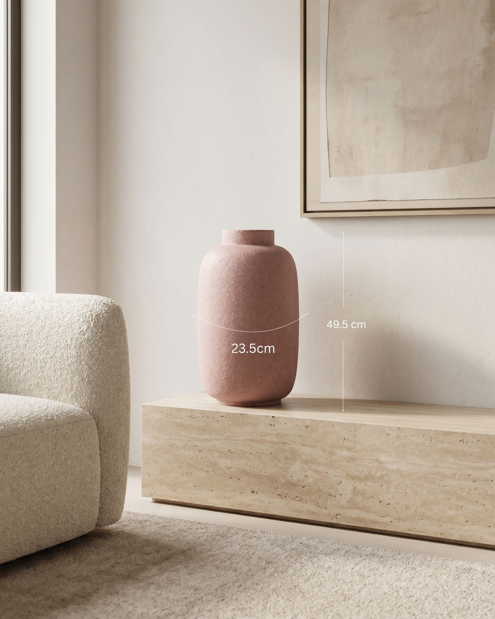 Pink vase on a wooden side table in a minimalistic room with a sofa and framed picture.