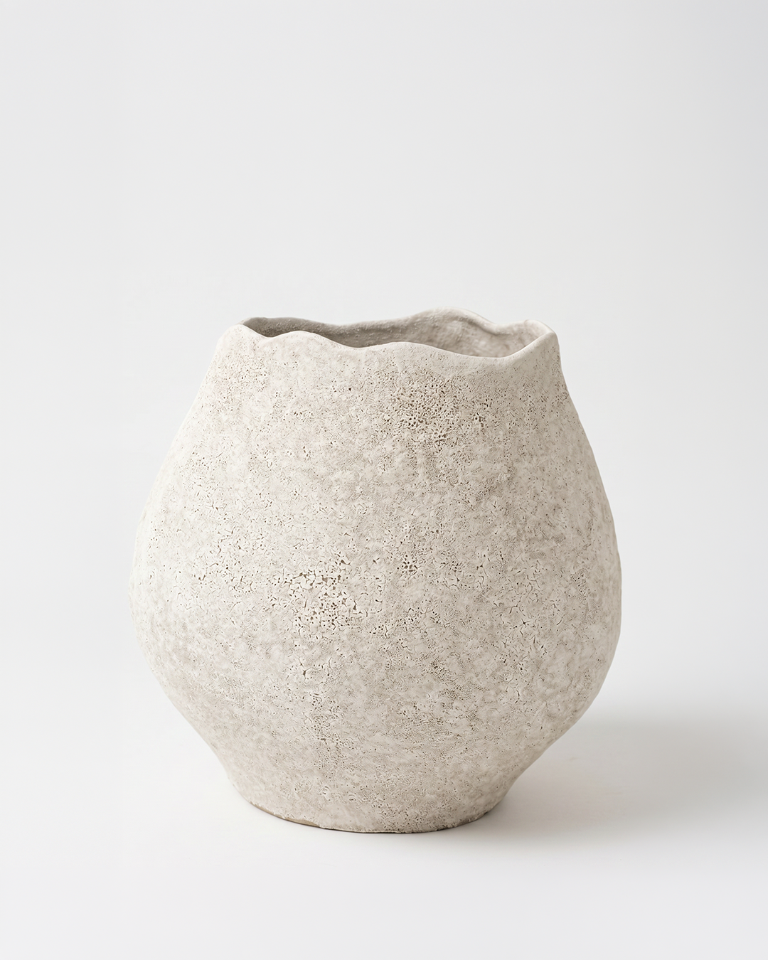 Textured ceramic vase on a light gray background